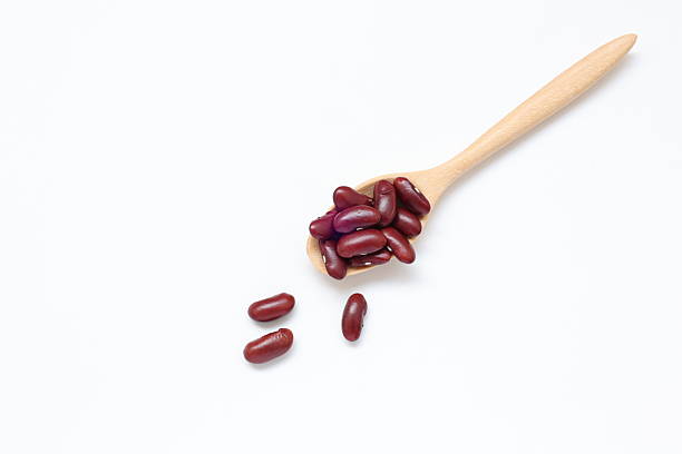 istock Red kidney beans in spoon on white background 2205629847