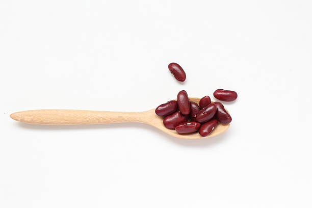 istock Red kidney beans in spoon on white background 2205629867