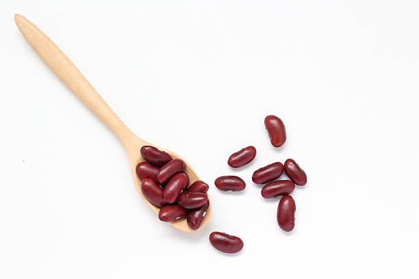 istock Red kidney beans in spoon on white background 2205629869