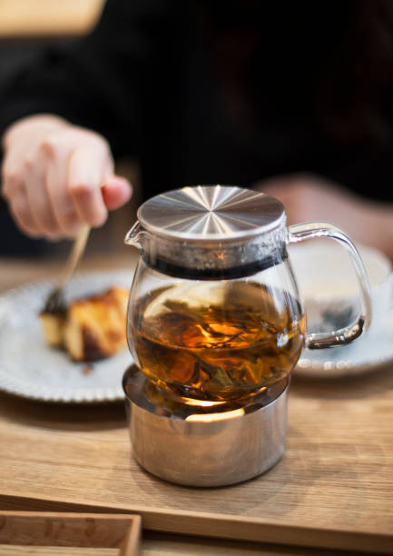 istock Glass Teapot with Loose Leaf Tea on Warmer 2205632749