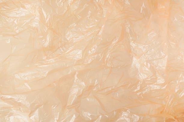 istock A background of crumpled and wrinkled orange plastic sheets. Concept for zero waste and micro plastic pollution. 2205633937