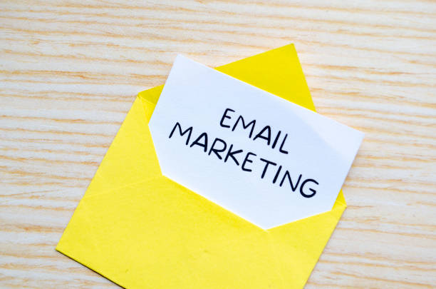 istock Email marketing text on white notepad inside a yellow envelope. Making money online concept 2205635663