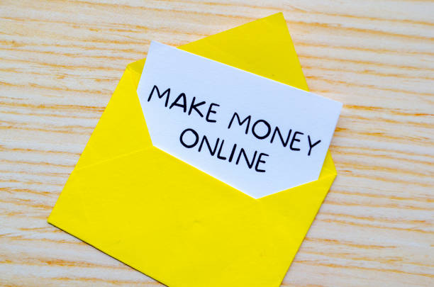 istock Make Money Online text on white notepad inside a yellow envelope. Making money online concept 2205635671