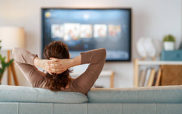 istock Woman watching  TV 2205635978