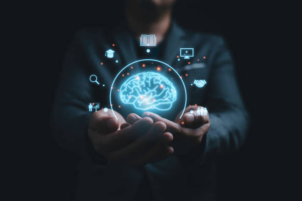istock Businessman holding virtual glowing Brain with knowledge icons for study concept. 2205636096