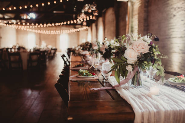 istock Wedding reception with flower centerpieces and place settings 2205636158