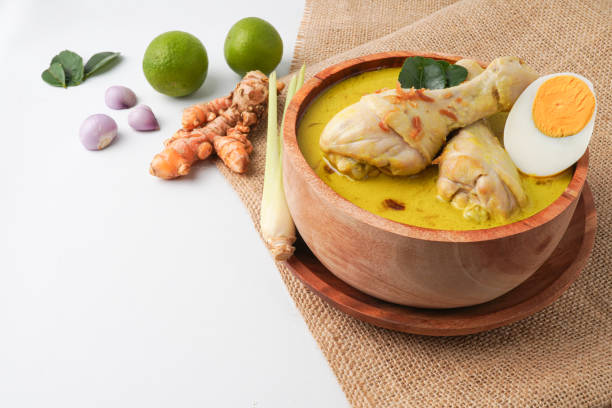 istock Lontong opor ayam is an Indonesian traditional dish usually served during eid Mubarak, Eid al Fitr holiday celebration with Ketupat Lebaran or rice cake dumpling and sambal chili sauce. 2205636983
