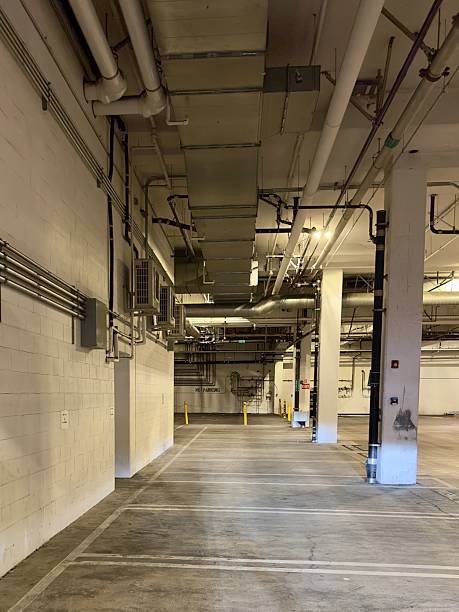 istock Intricate Pipe Work in Underground Parking Garage 2205637587