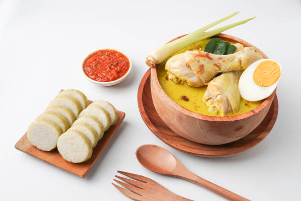 istock Lontong opor ayam is an Indonesian traditional dish usually served during eid Mubarak, Eid al Fitr holiday celebration with Ketupat Lebaran or rice cake dumpling and sambal chili sauce. 2205639129