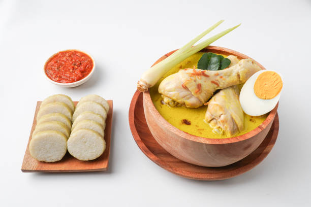 istock Lontong opor ayam is an Indonesian traditional dish usually served during eid Mubarak, Eid al Fitr holiday celebration with Ketupat Lebaran or rice cake dumpling and sambal chili sauce. 2205639131