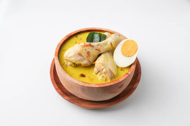 istock Lontong opor ayam is an Indonesian traditional dish usually served during eid Mubarak, Eid al Fitr holiday celebration with Ketupat Lebaran or rice cake dumpling and sambal chili sauce. 2205639145