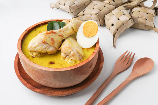 istock Lontong opor ayam is an Indonesian traditional dish usually served during eid Mubarak, Eid al Fitr holiday celebration with Ketupat Lebaran or rice cake dumpling and sambal chili sauce. 2205639403