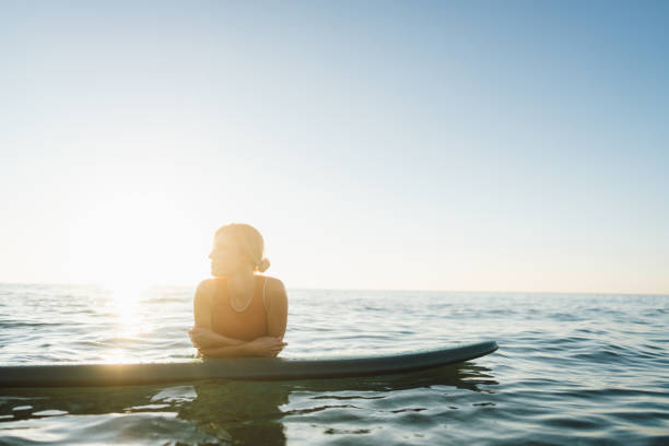 istock Surfer girl and her surfboard 2205643856