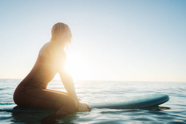 istock Surfer girl and her surfboard 2205643859
