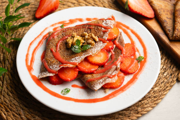 istock Chocolate crepes with fruit, strawberries and bananas. 2205643972