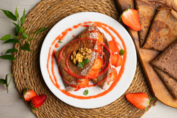 istock Chocolate crepes with fruit, strawberries and bananas. 2205643987