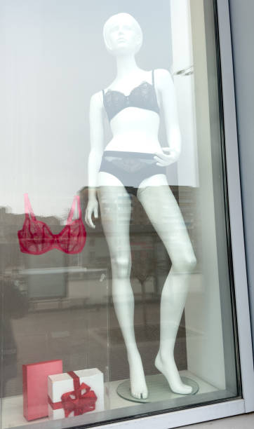 istock A mannequin wearing a black bra and panties is displayed in a window 2205645218