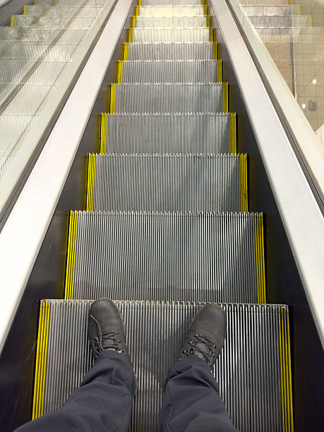 istock A person is standing on the steps of an escalator 2205645296