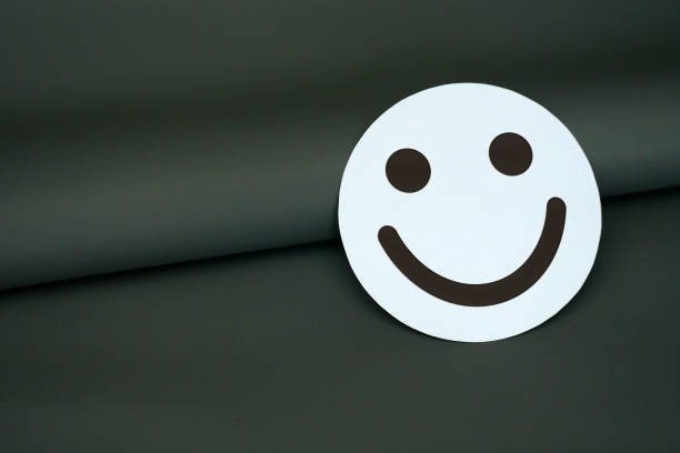istock Minimalist White Smiley Face on Dark Green Background Symbolizing Simplicity, Positivity 2205645572