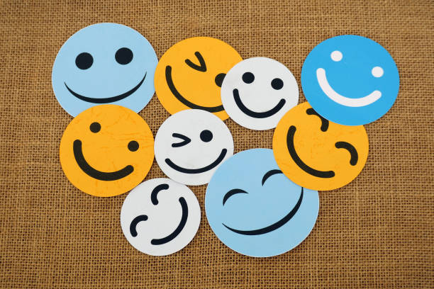 Smiling White Face Emoji on Dark Green Folded Background Representing Happiness, Positivity, and Optimistic Emotions