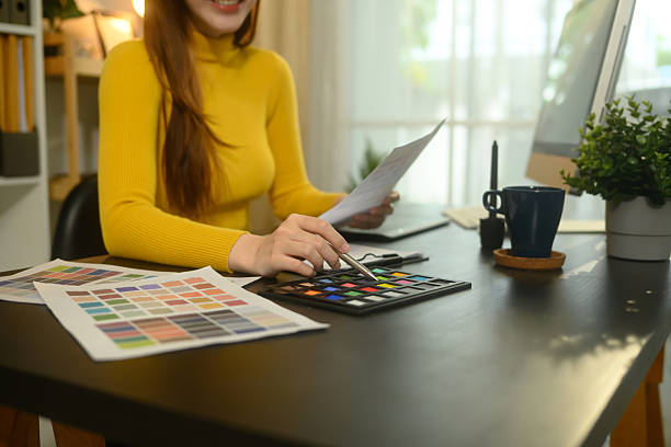 istock Smiling young graphic designer working with color swatches in a creative office 2205646729