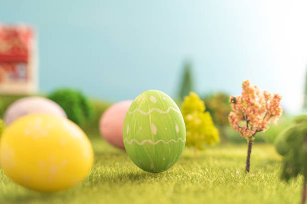 istock In the middle of a vast grassy field, there sits a pink easter egg 2205647079