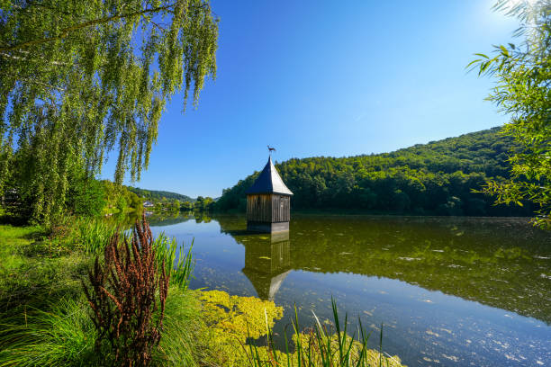 Church in the lake in the Reiherbach near Nieder-Werbe. Church tower top in the Reiherbach reservoir on the Edersee. Old village church of the town. stock photo