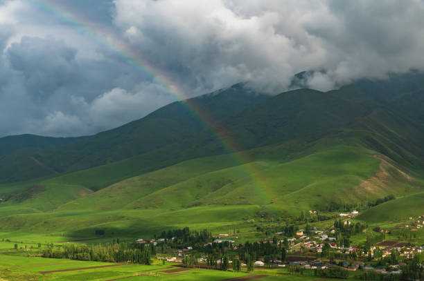 Rainbow after rain in a mountain valley.