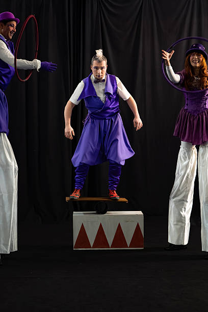 Circus performers balancing and juggling on stage