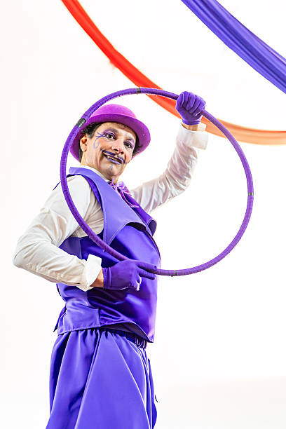 Linz, Austria - 07 20 2023 - A street performer juggling some hula hoops at the Linz Pavement Spectacle, one of the most important and diverse street art festivals in Europe