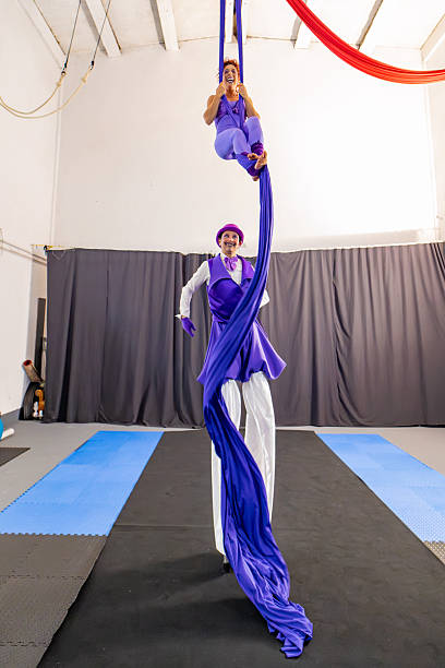 istock Two circus performers training with aerial silks and stilts 2205652334