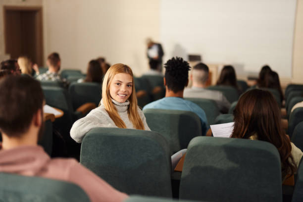 istock Happy female student on a class in amphitheater. 2205654583