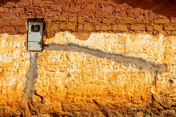 Barichara, Colombia, 05 12 2024 : Unconventional electricity Meter Installation on Adobe and Stone Wall  Barichara, Santander Colombia