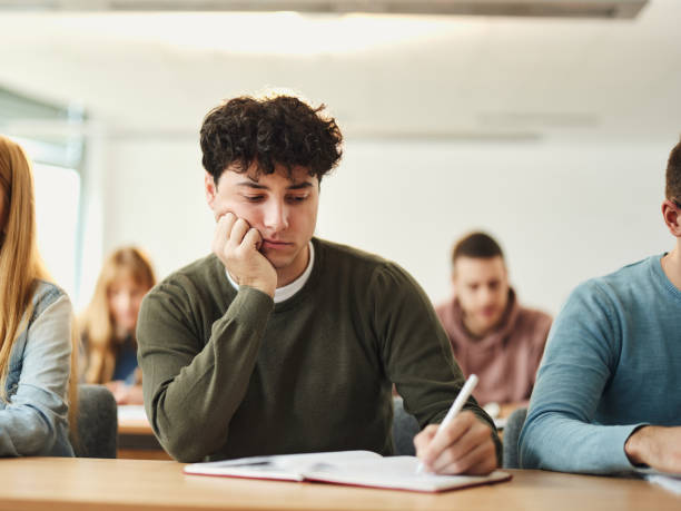 istock High school student writing an exam in the classroom. 2205655252