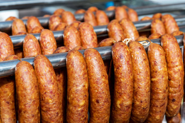 Homemade sausages hanging in a row