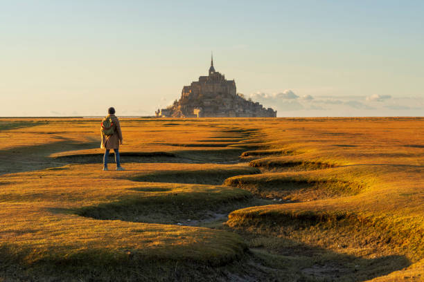 istock Tourist looking at Le Mont Saint Michel 2205658208