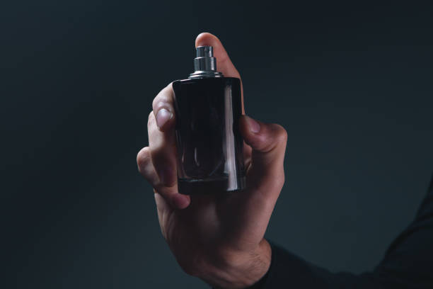 istock hand with bottle of perfume 2205659624