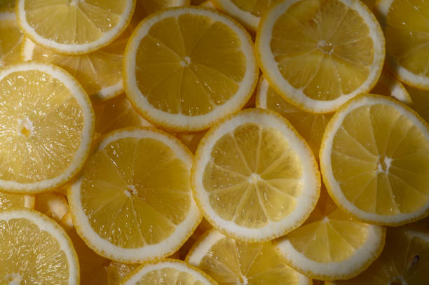 istock Bright and vibrant lemon slices arranged artistically on a surface capturing the essence of freshness and summer flavors 2205659750