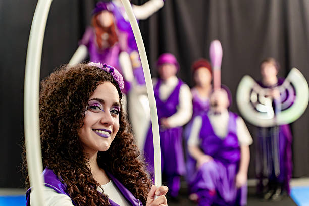istock Young artist smiling while holding a hoop in a circus show 2205660886