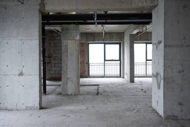 istock Unfinished building showing concrete pillars, pipes and windows 2205663626