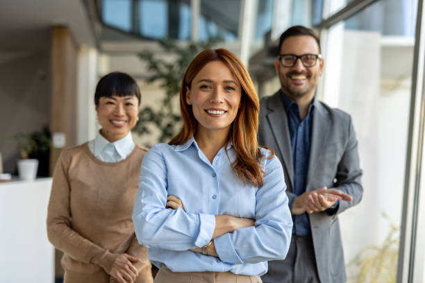 istock Confident business team smiling at camera in modern office 2205664593