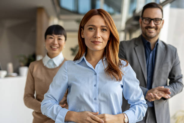 istock Confident businesswoman leading diverse team in modern office 2205664596
