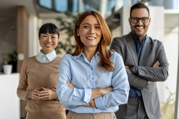 istock Confident business team smiling with arms crossed in office 2205664601