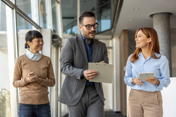 istock Business team walking and discussing a project in office corridor 2205664679