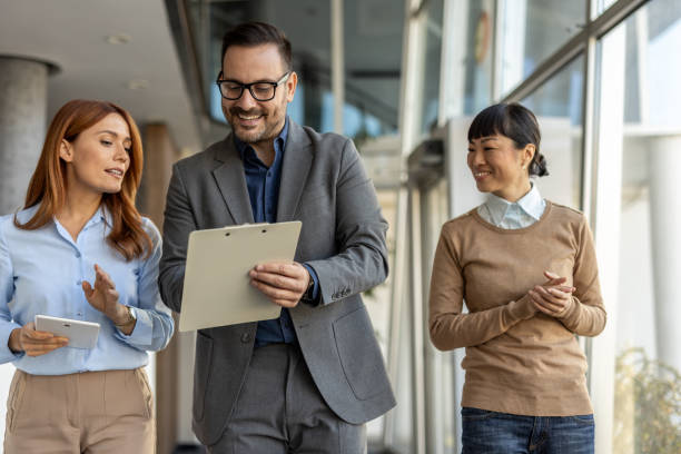 istock Business team walking and discussing a project in office corridor 2205664681