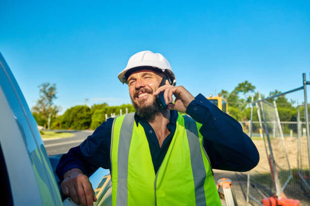 istock Smiling engineer talking on mobile phone at construction site in australia 2205665794