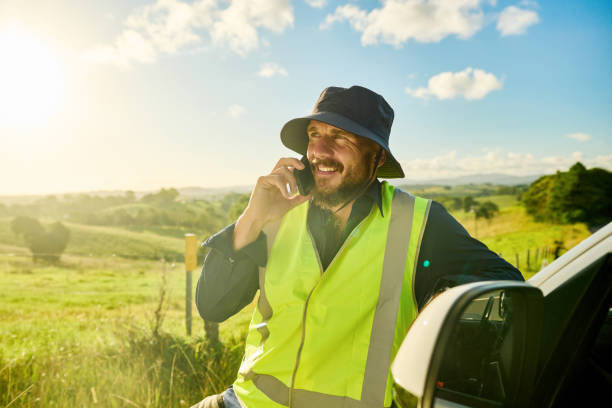 istock Smiling engineer making a phone call on construction site in rural australia 2205665810