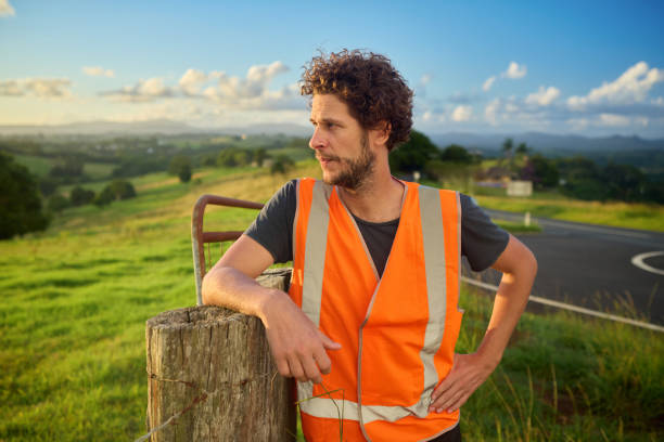 istock Engineer wearing high-visibility vest planning in the australian countryside 2205665837
