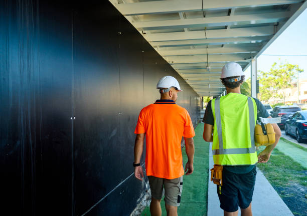istock Engineers discussing building plans at construction site in australia 2205665875