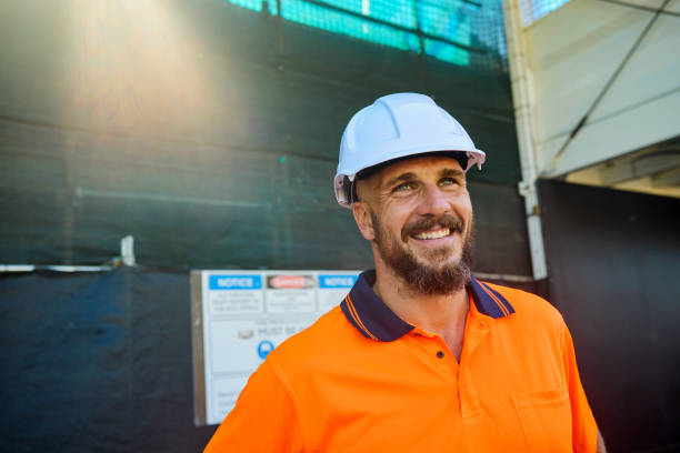 istock Smiling engineer wearing hardhat at construction site in australia 2205665908